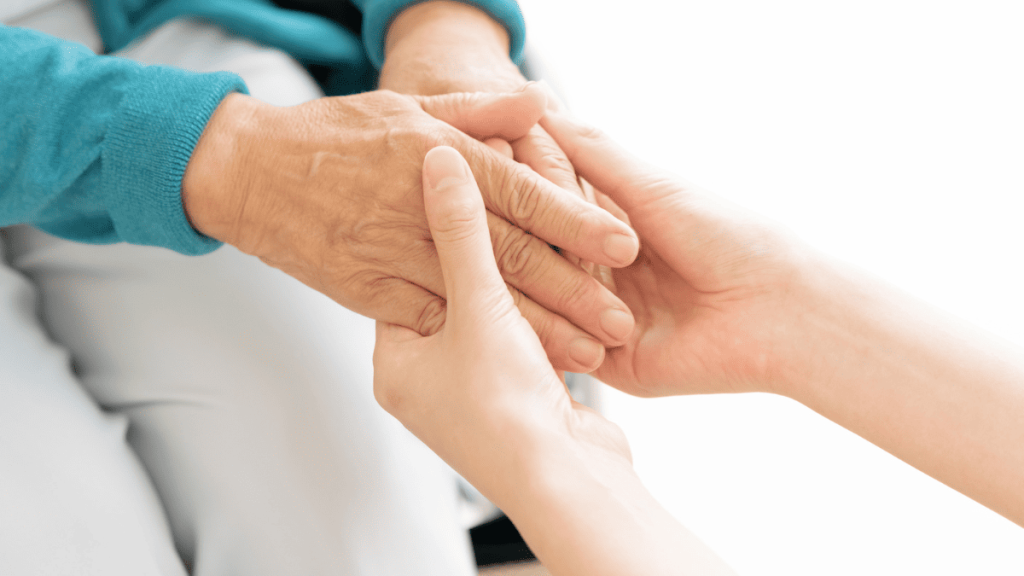 老人女性の手を握る看護師