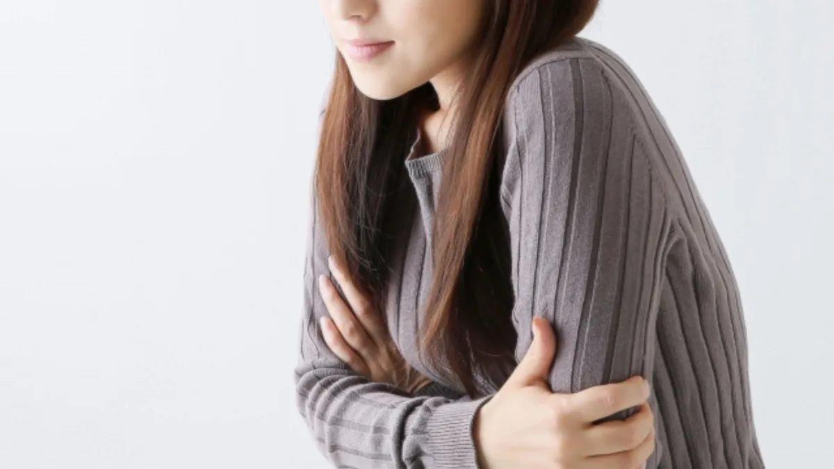 寒さで縮こまる女性