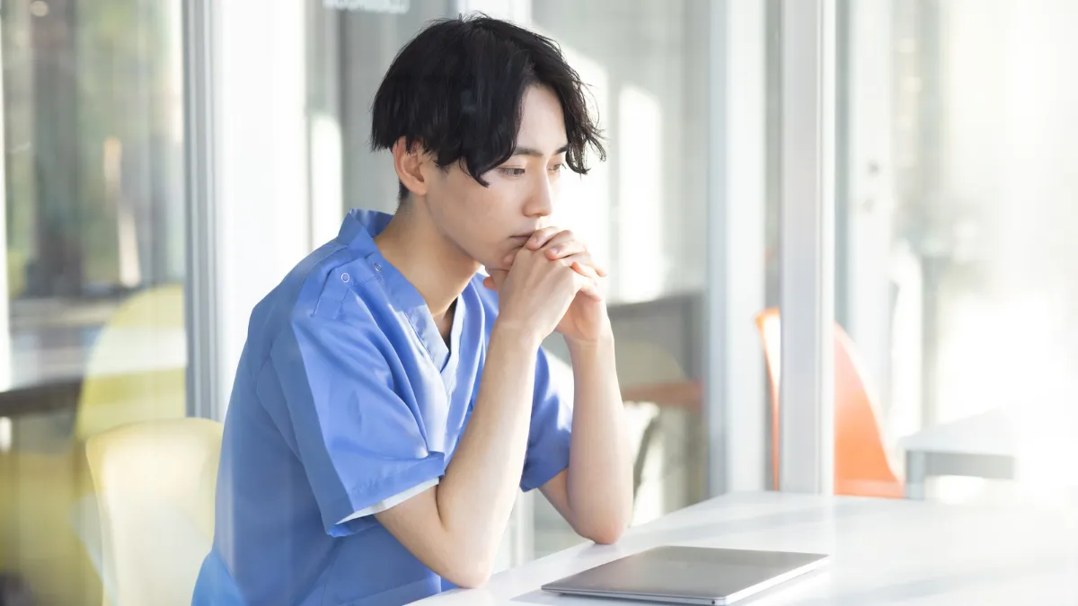 悩んでいる柔道整復師の様子