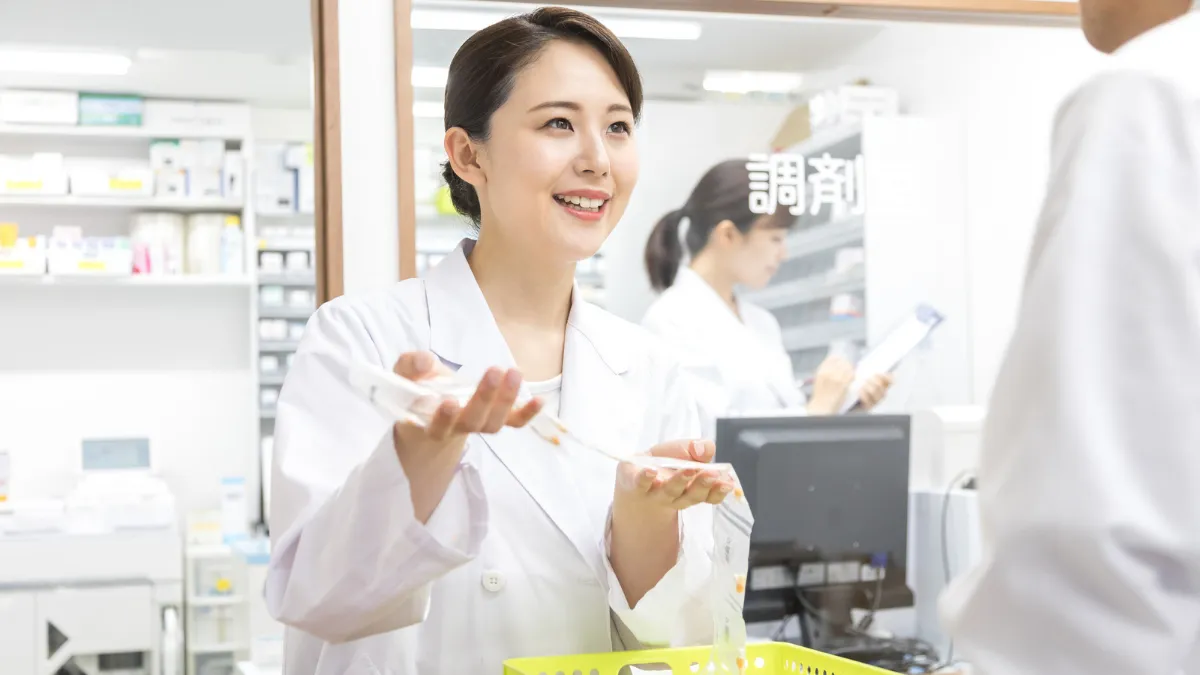 調剤薬局で薬について説明する薬剤師